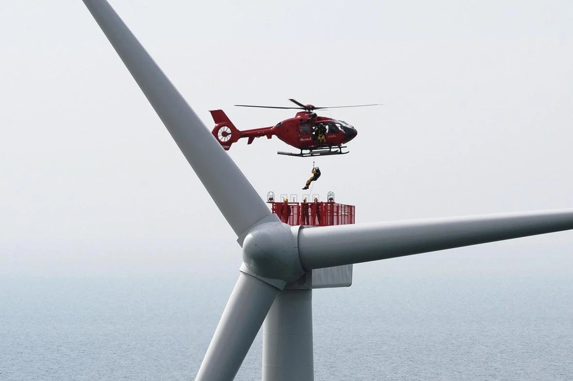 Crew lifted to wind turbine by helicopter